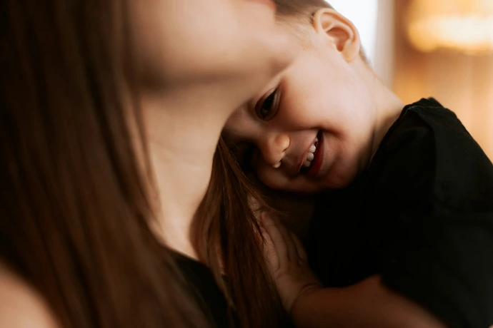 A woman holding a small child in her arms